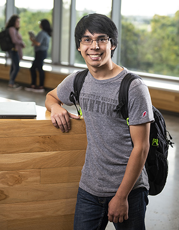 Student standing with UHD shirt