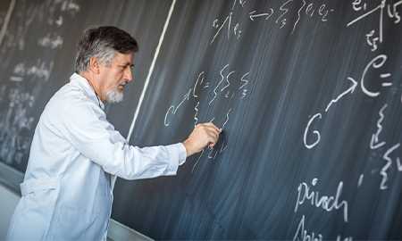 Man writing on chalk board