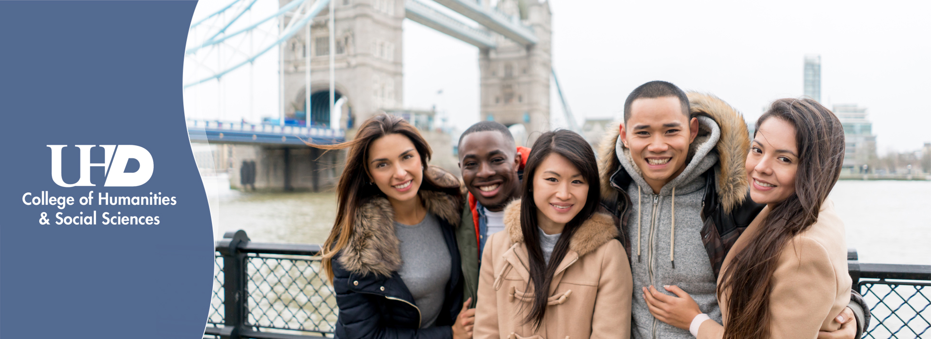 diverse group of college students posing in front of the tower bridge in London, England