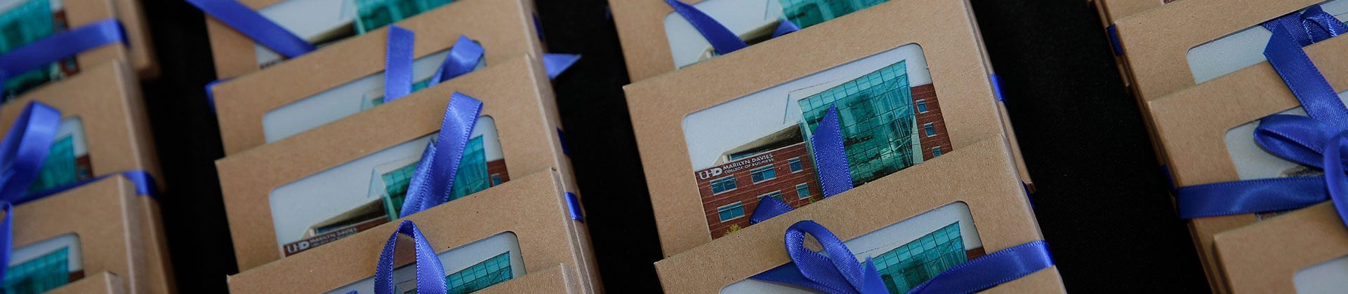 thank you cards with MDCOB printed on it wrapped in a blue ribbon