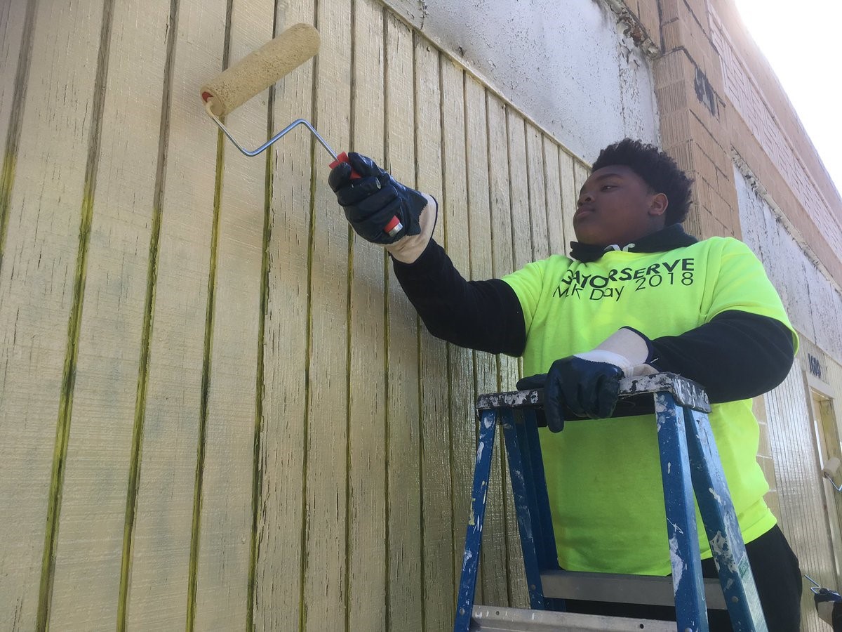 Man Painting over graffiti