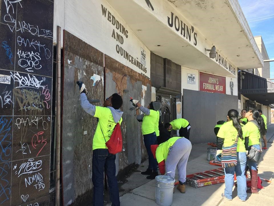 Students Painting over graffiti
