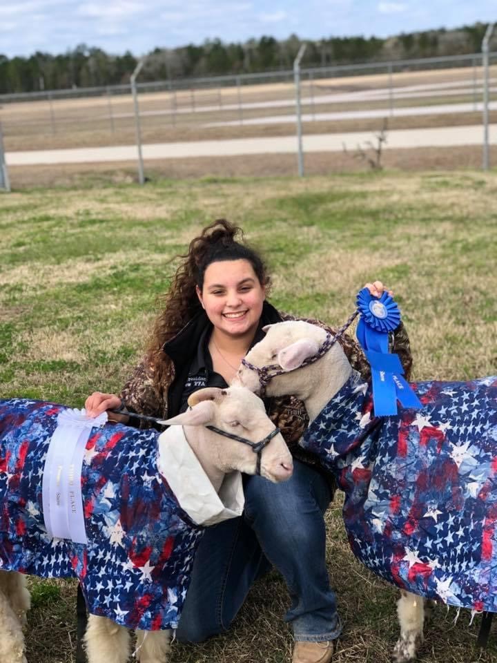 Ashlyn Pena with two lambs