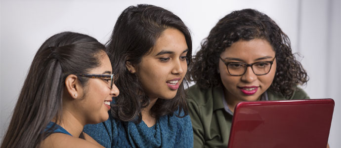 3 female students workingon a laptop
